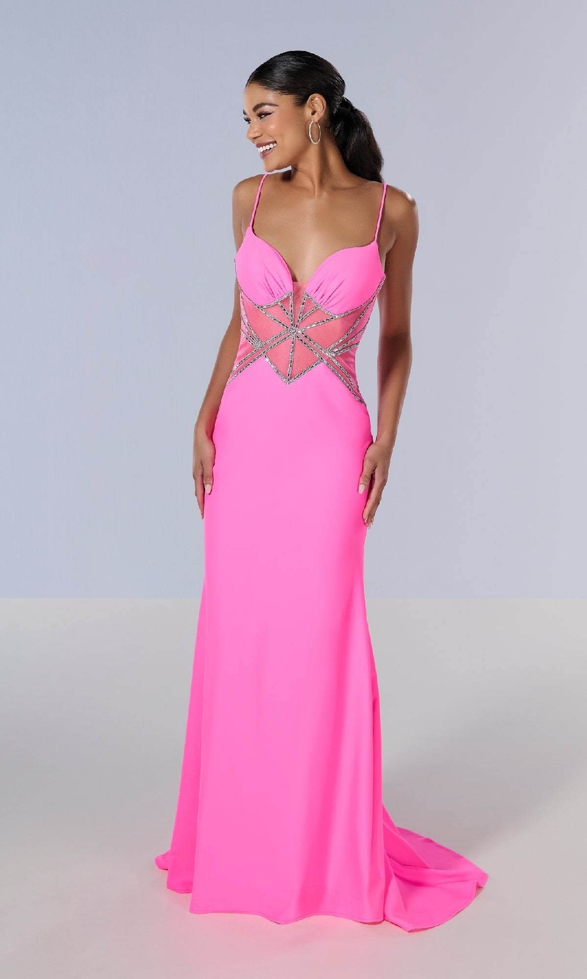 A woman wears the Tiffany 16201 long prom dress—a bright pink, slim-fit gown with spaghetti straps and silver embellished geometric waist designs—standing against a plain background.